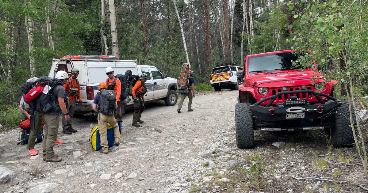 Search and rescue workers prepare to reach a stranded hiker.