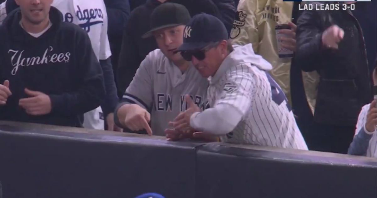 Yankees fans Austin Capobianco and John Peter were kicked out of Game 4 of World Series on Tuesday after they interfered with an outfield catch.