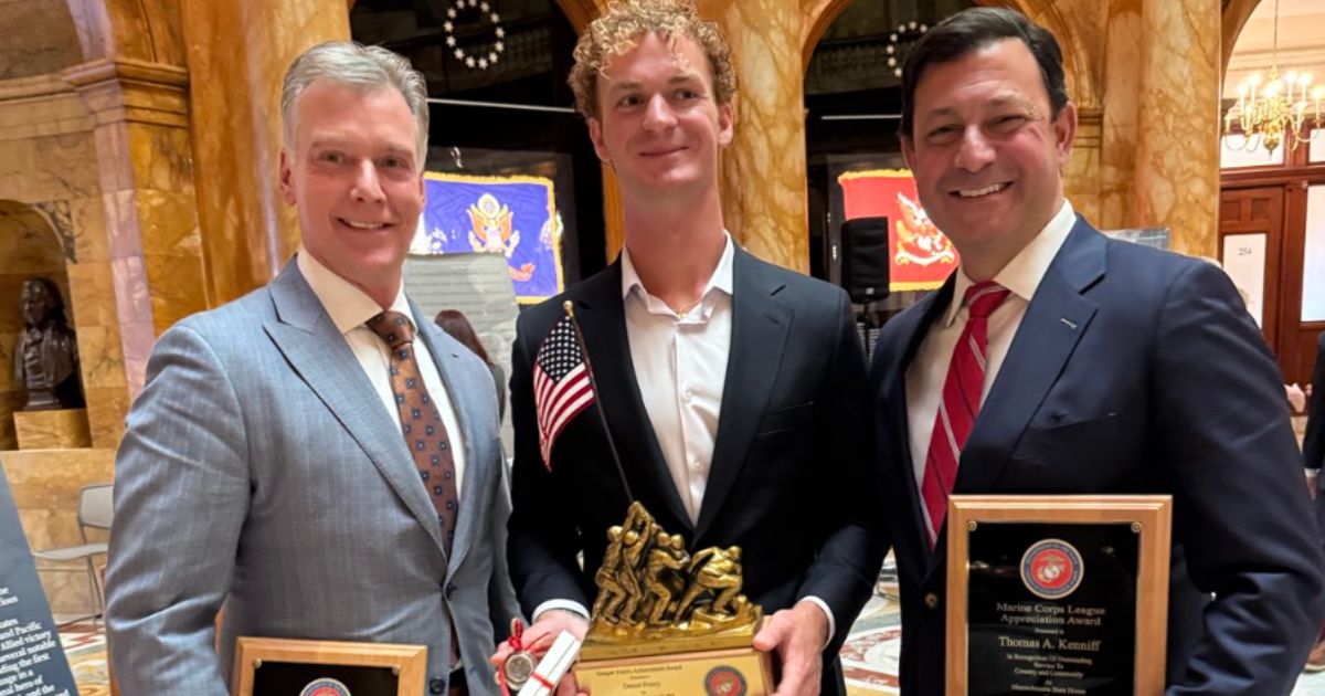 Daniel Penny, center, received a Semper Fidelis achievement award, along with his attorneys Steve Raiser, left, and Thomas Kenniff, from the Marine Corps League.