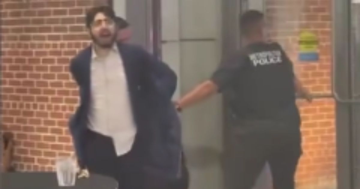 Elias Rodriguez is taken into police custody in Washington, D.C., on Thursday as a suspect in the murder of two Israeli diplomats.