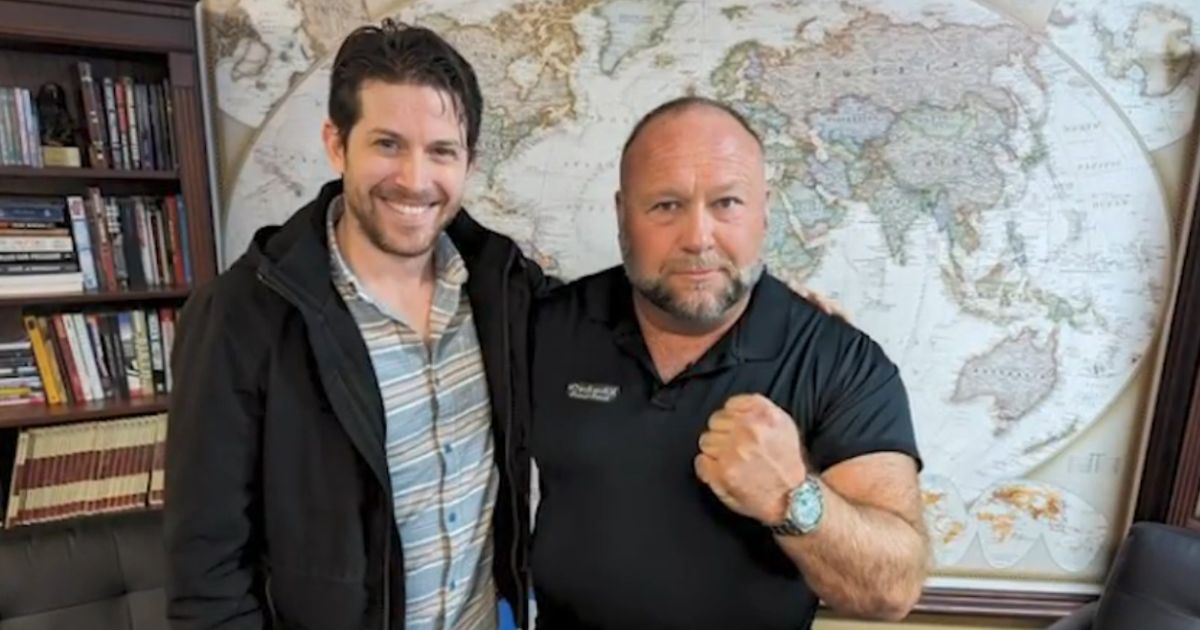 Jamie White, a murdered InfoWars reporter, stands alongside Alex Jones.