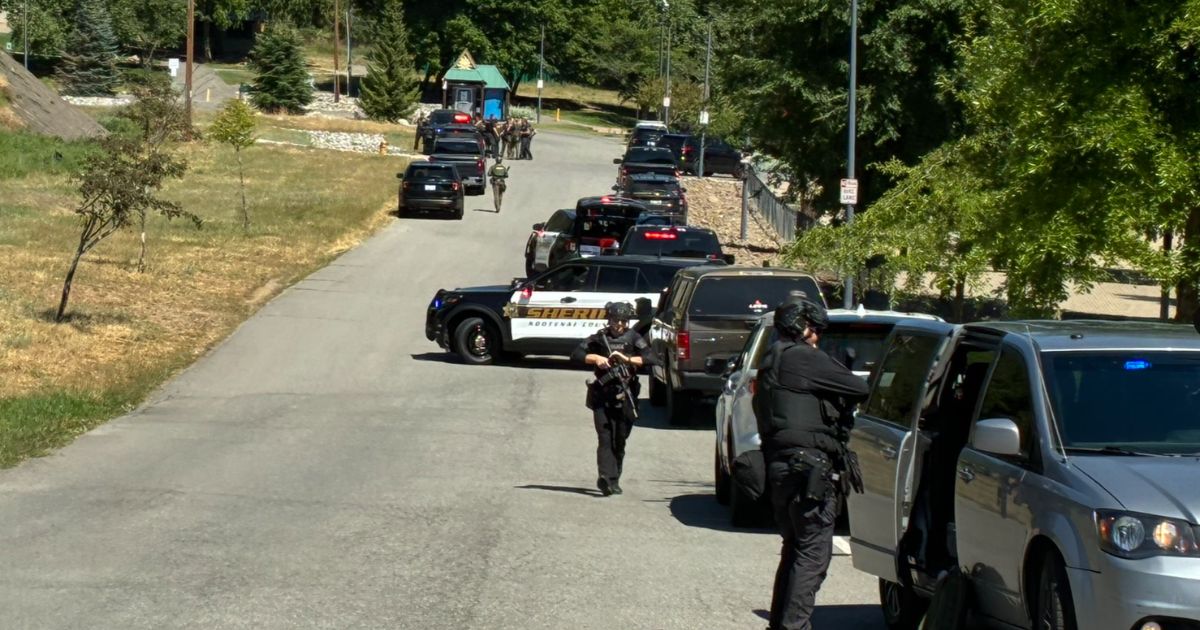 Kootenai County Sheriff's Office officers and other members of law enforcement arrive at an active shooting scene in Coeur d'Alene, Idaho, on Sunday.