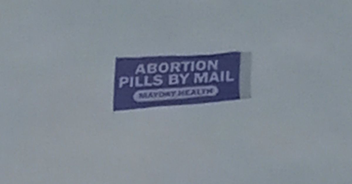 Banner being flown behind a plane at the Indy 500 at the Indianapolis Motor Speedway.